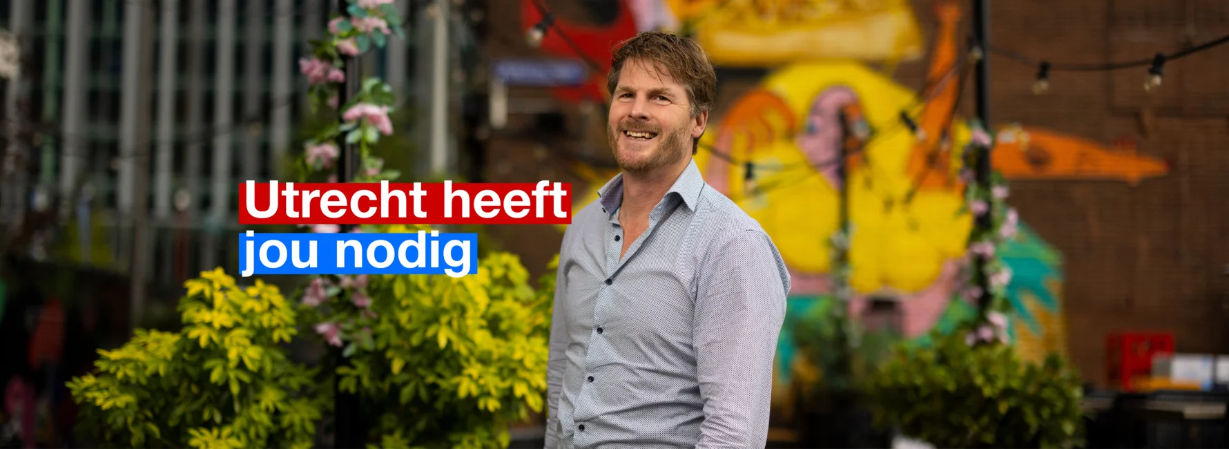 Lachende man met overhemd aan voor een kleurrijke achtergrond